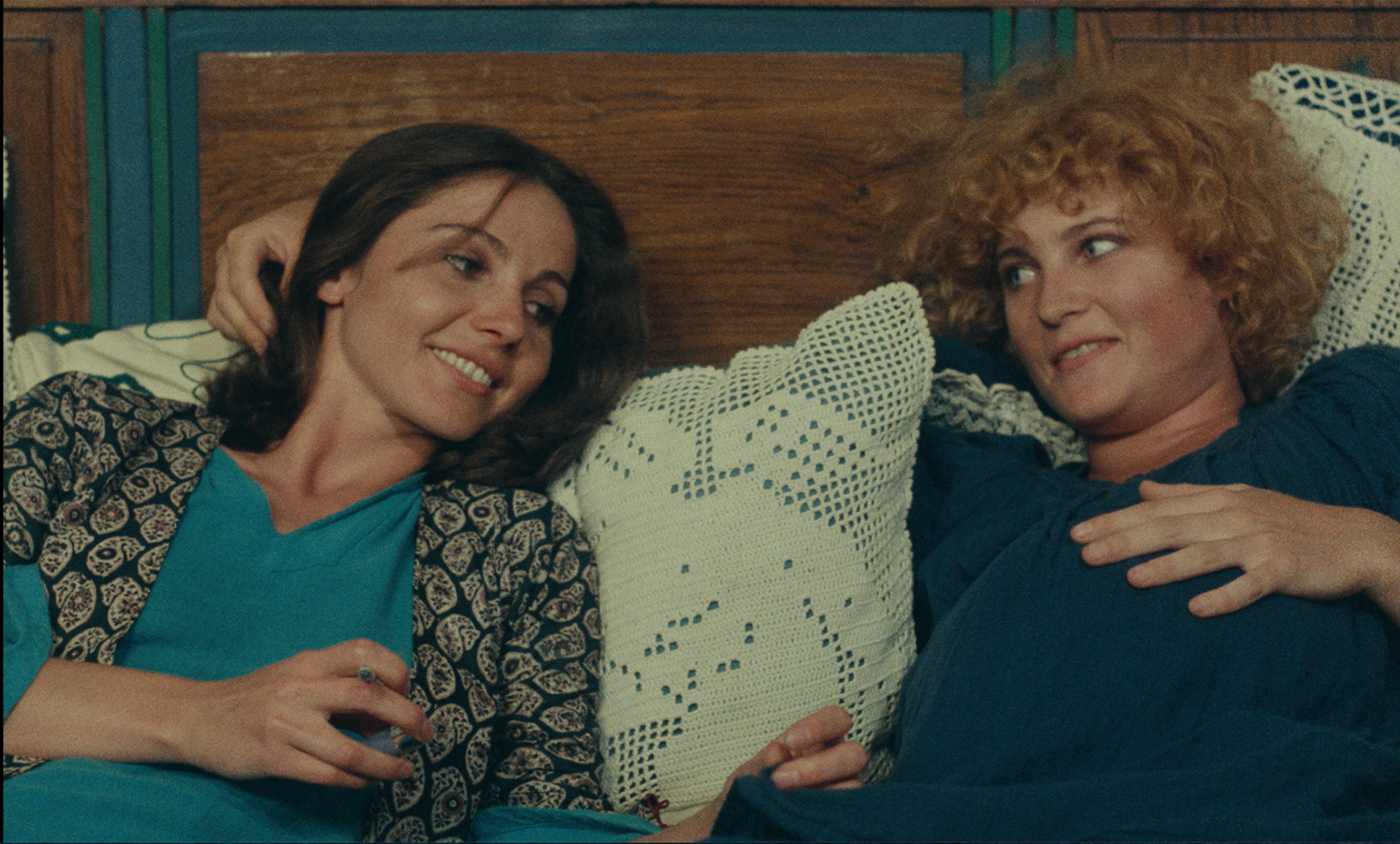 Thérèse Liotard and Valérie Mairesse lounge next to one another and talk in a still from Agnès Varda's 1977 film, "One Sings, the Other Doesn't"